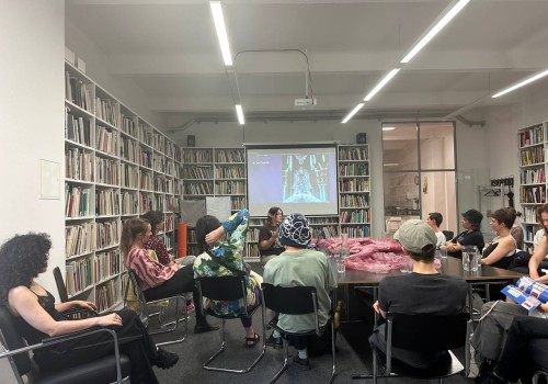 Frances Breden presenting in a room full of people.